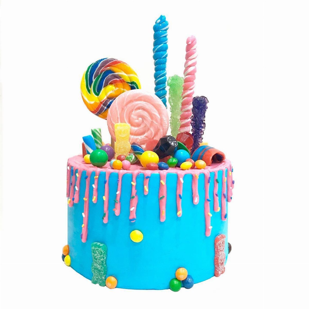Candy overload drip cake with colorful candies and dripping icing.