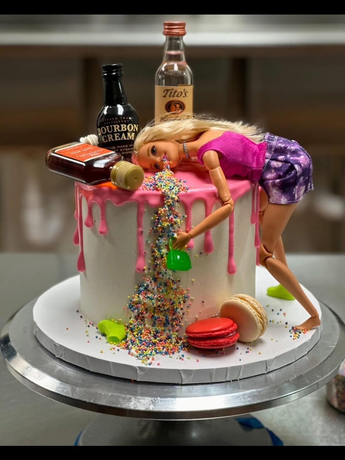 Drunk Barbie Cake with pink drip icing and a Barbie doll spilling sprinkles.