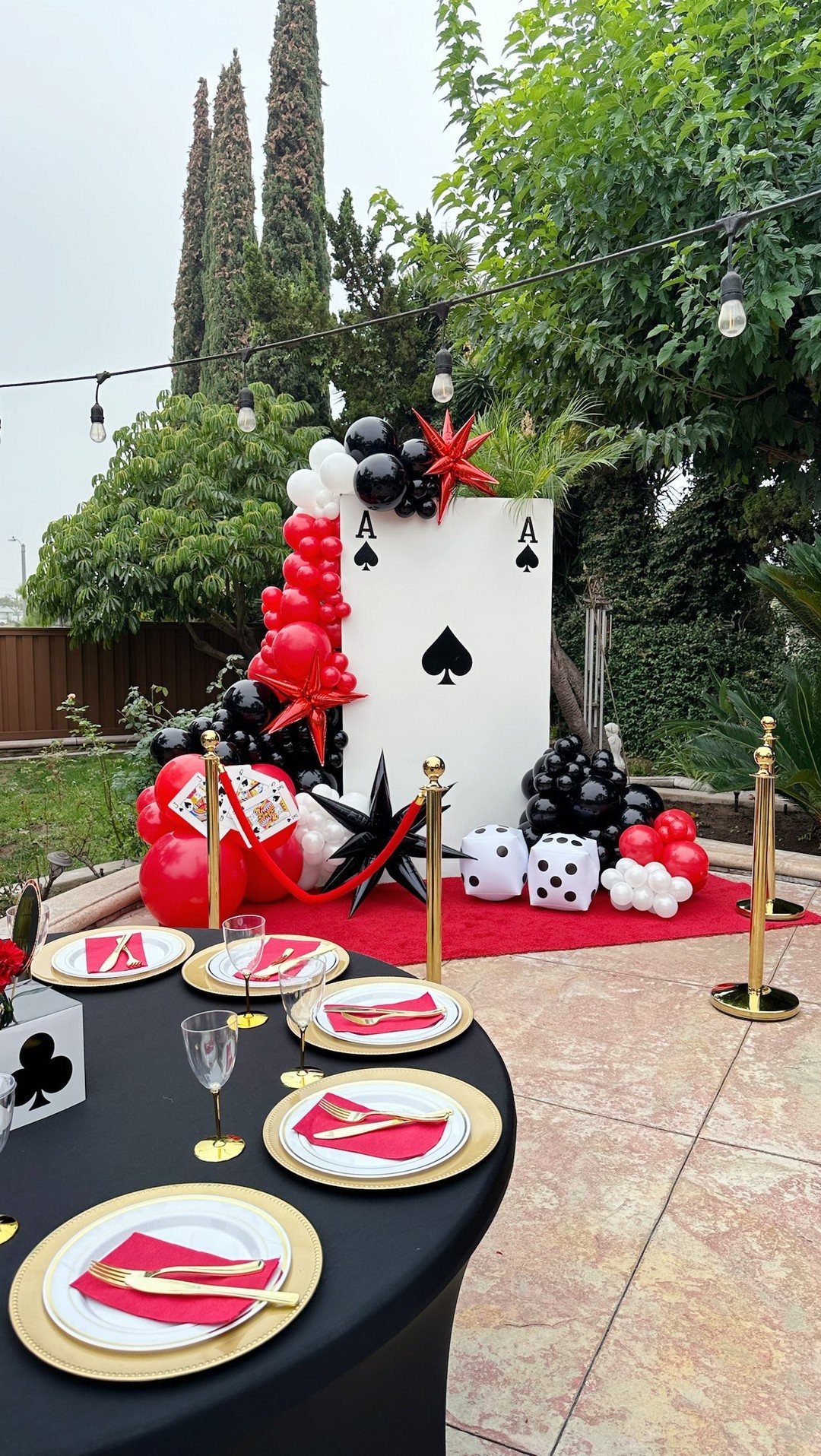 Casino-themed decorations with balloons, playing cards, and a festive table setting.