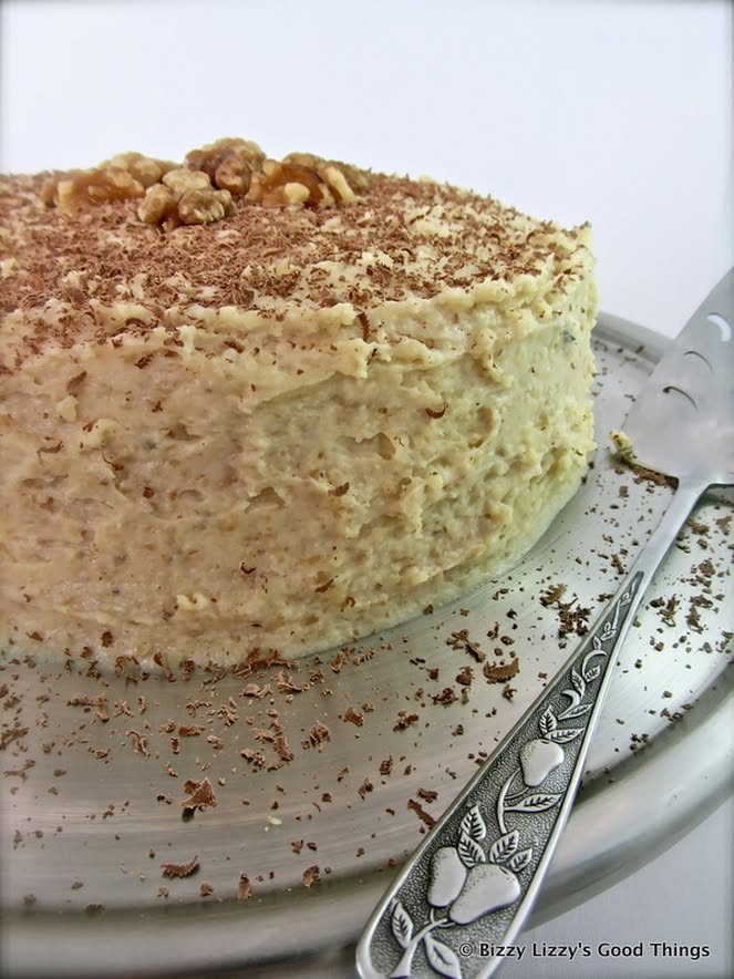 Walnut cream torte topped with walnuts and chocolate shavings.