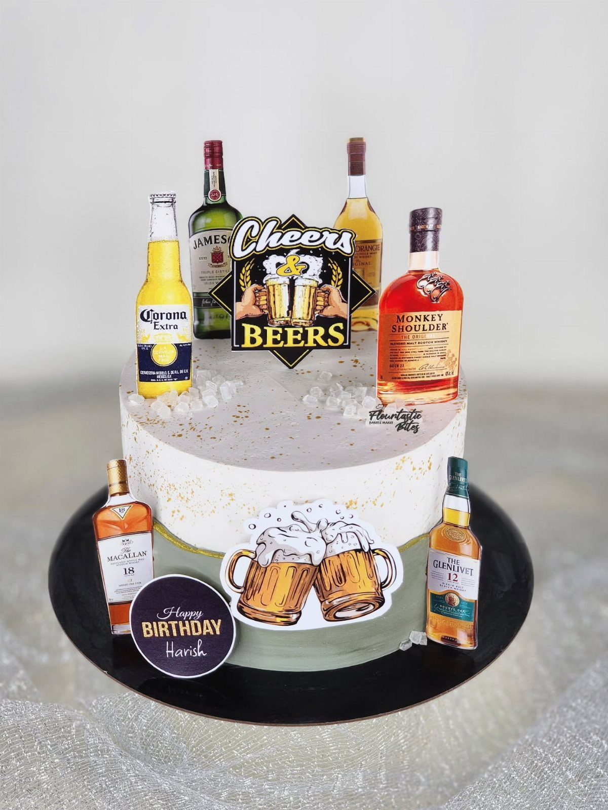 A two-tier birthday cake decorated with miniature liquor bottles and beer themed signs.