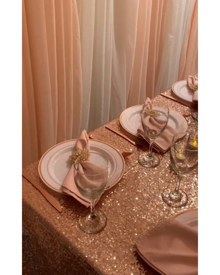 Rose gold sequined tablecloth with elegant place settings and blush pink napkins.