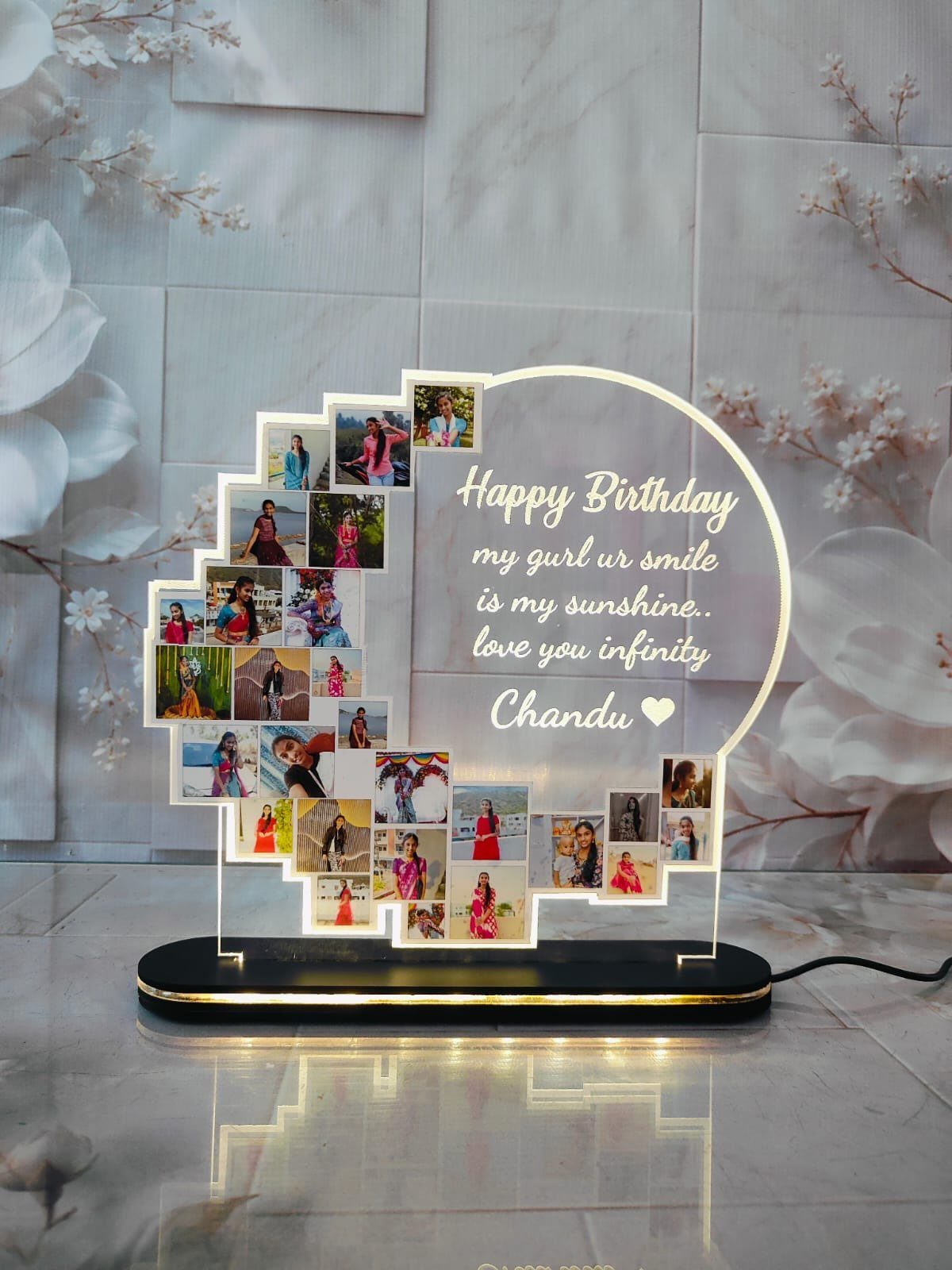 Customized acrylic LED lamp featuring a photo collage and a birthday message on a marble surface.