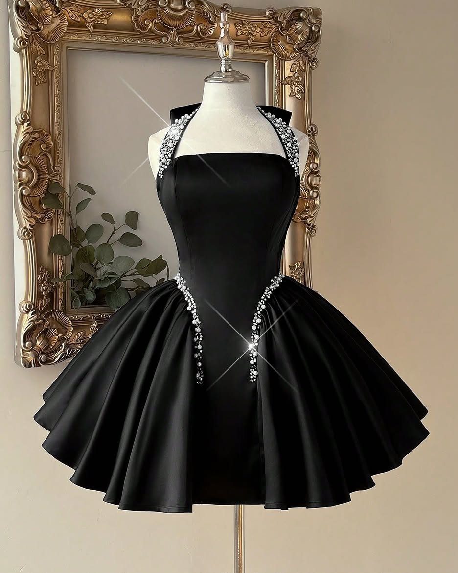 Black satin cocktail dress with silver rhinestone details on a mannequin torso.