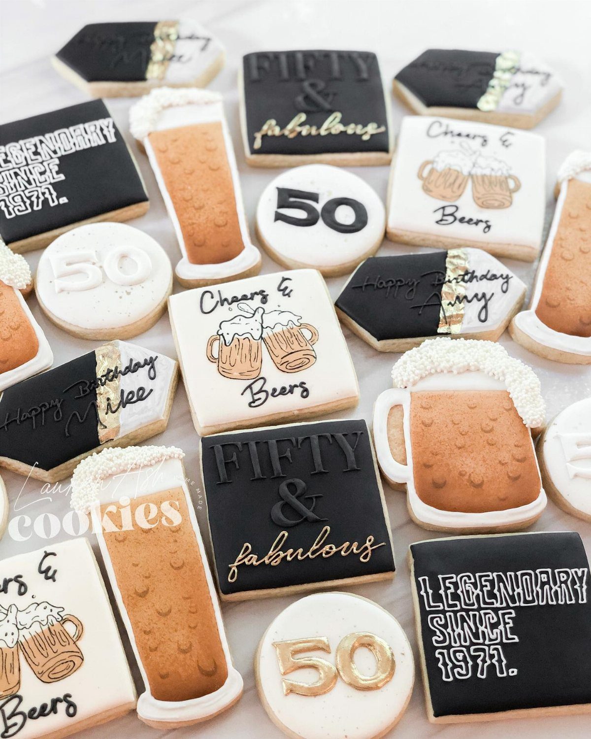 Decorated sugar cookies with beer mug designs and 50th birthday themed text.