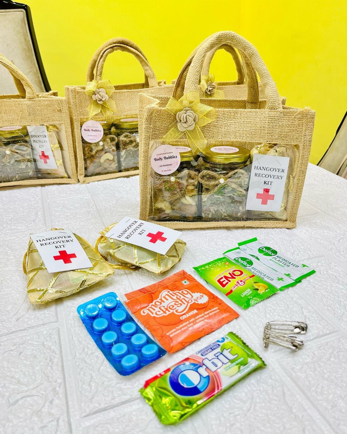 Burlap bags and various remedies like mints and candy arranged as hangover recovery kits.