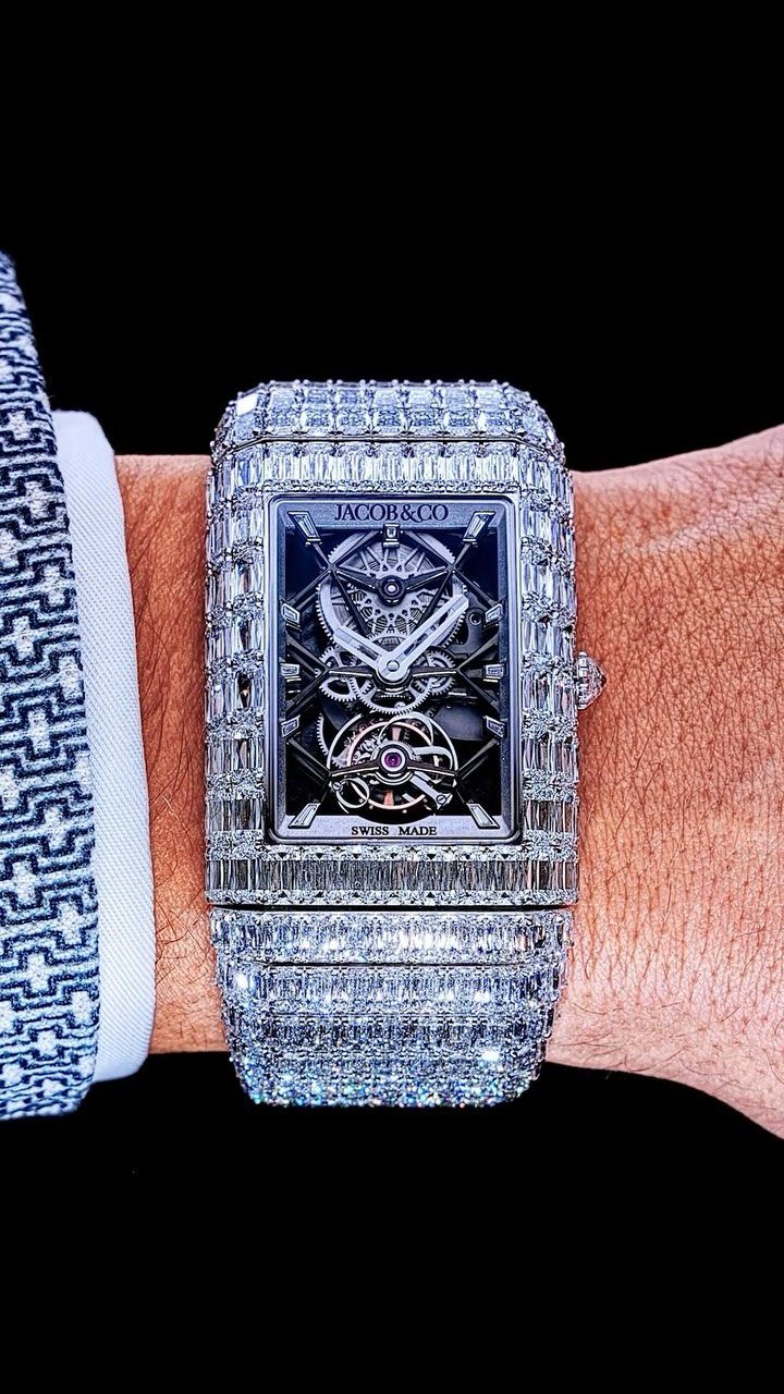A luxury diamond-encrusted rectangular wristwatch worn on a person's wrist.