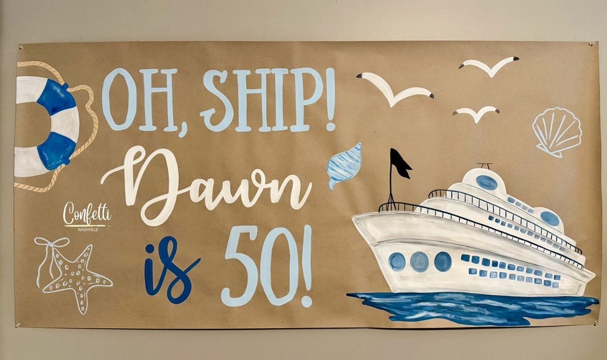 Hand-painted nautical banner with a cruise ship and text celebrating Dawn's 50th birthday.