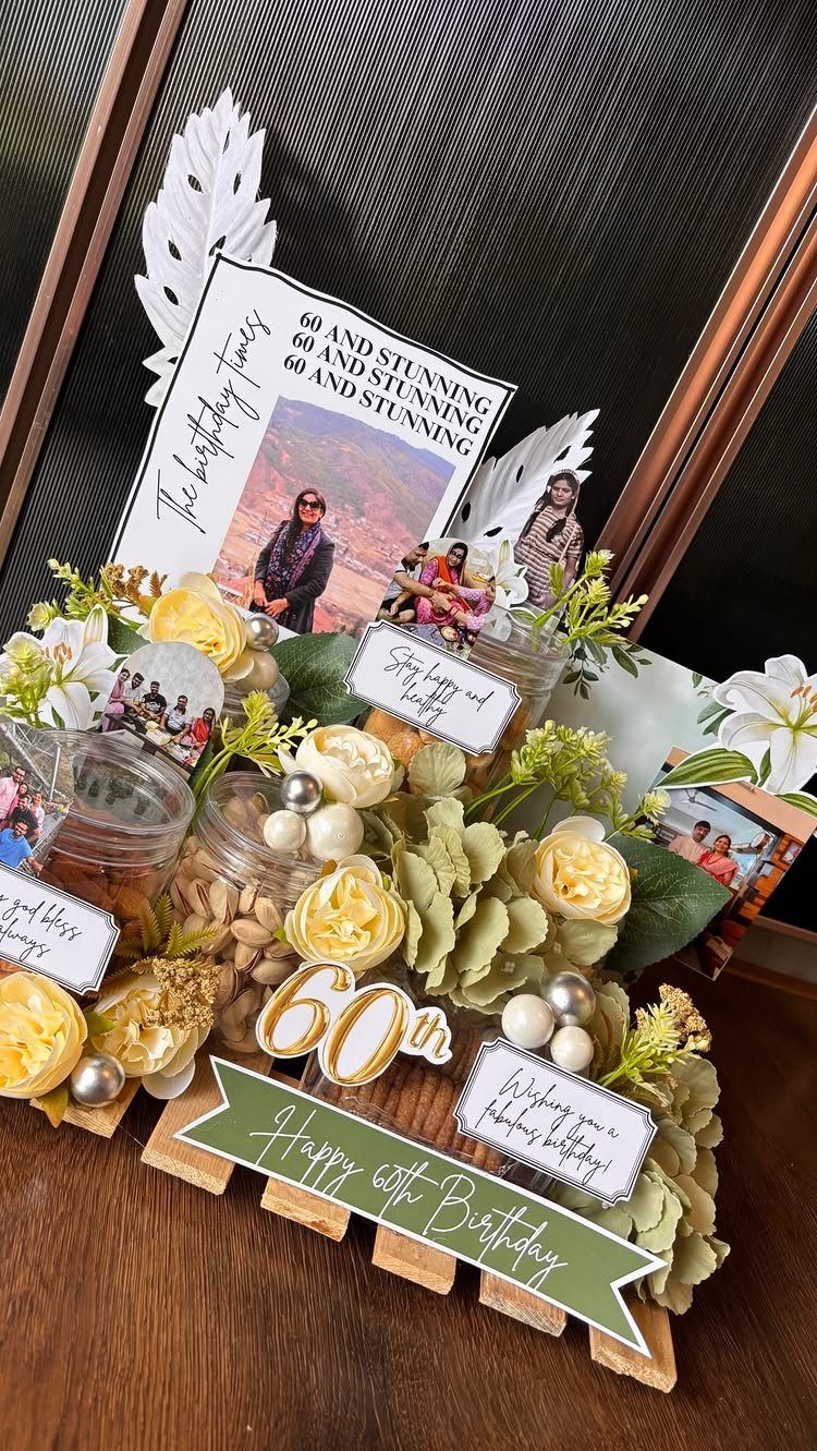 A personalized 60th birthday gift basket with flowers, snacks, and printed photographs.