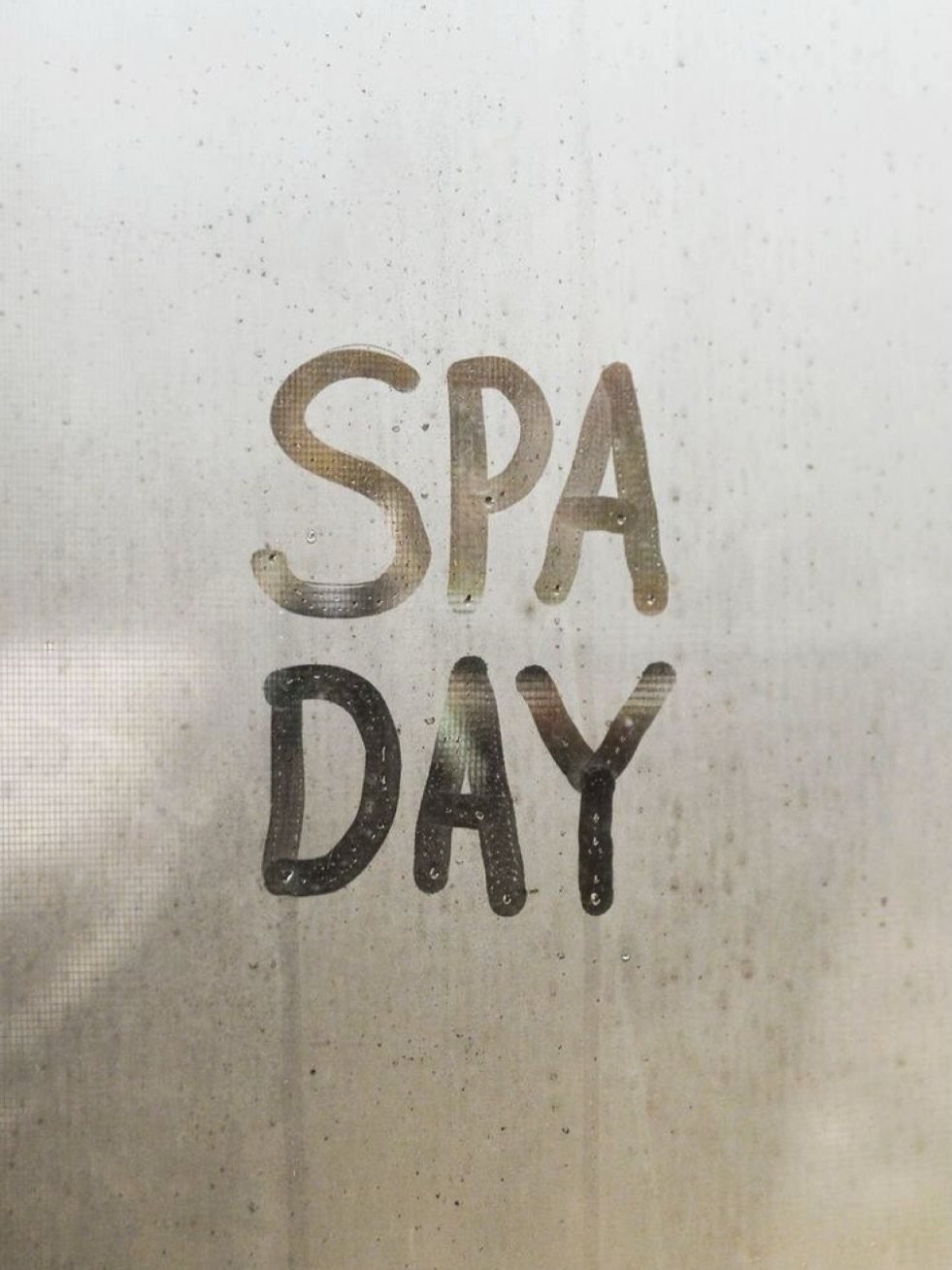 Hand-drawn text reading SPA DAY on a textured, light beige background.