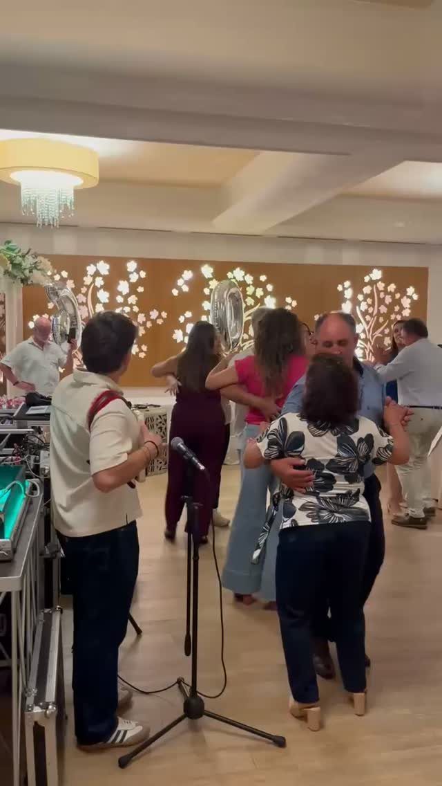 Adults dancing together in a decorated indoor room during a social celebration.
