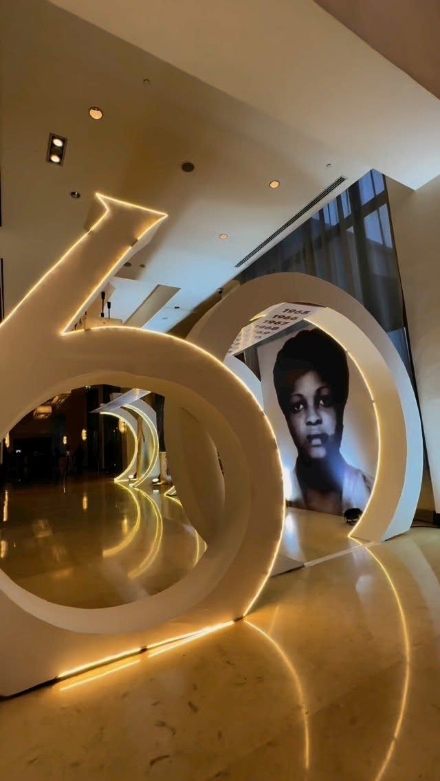 Large illuminated number sixty decorations featuring a black and white portrait inside the zero.