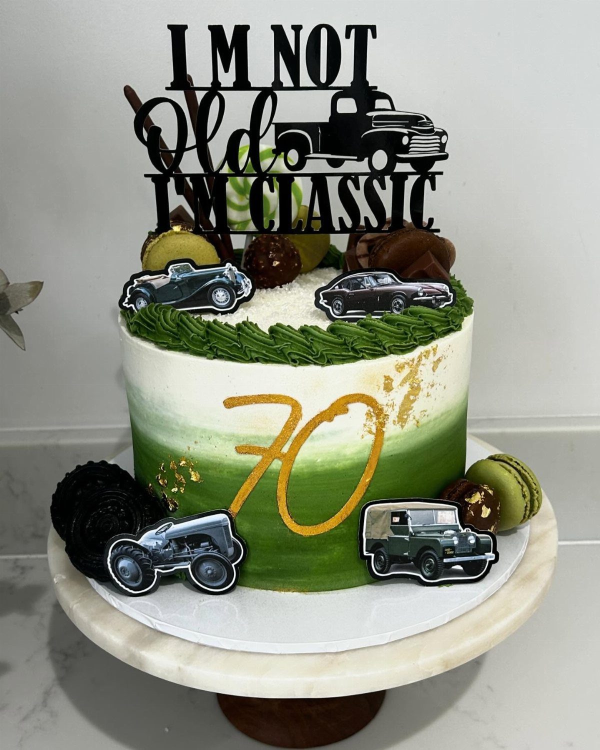 Green ombre cake with vintage car cutouts and a classic car themed topper.