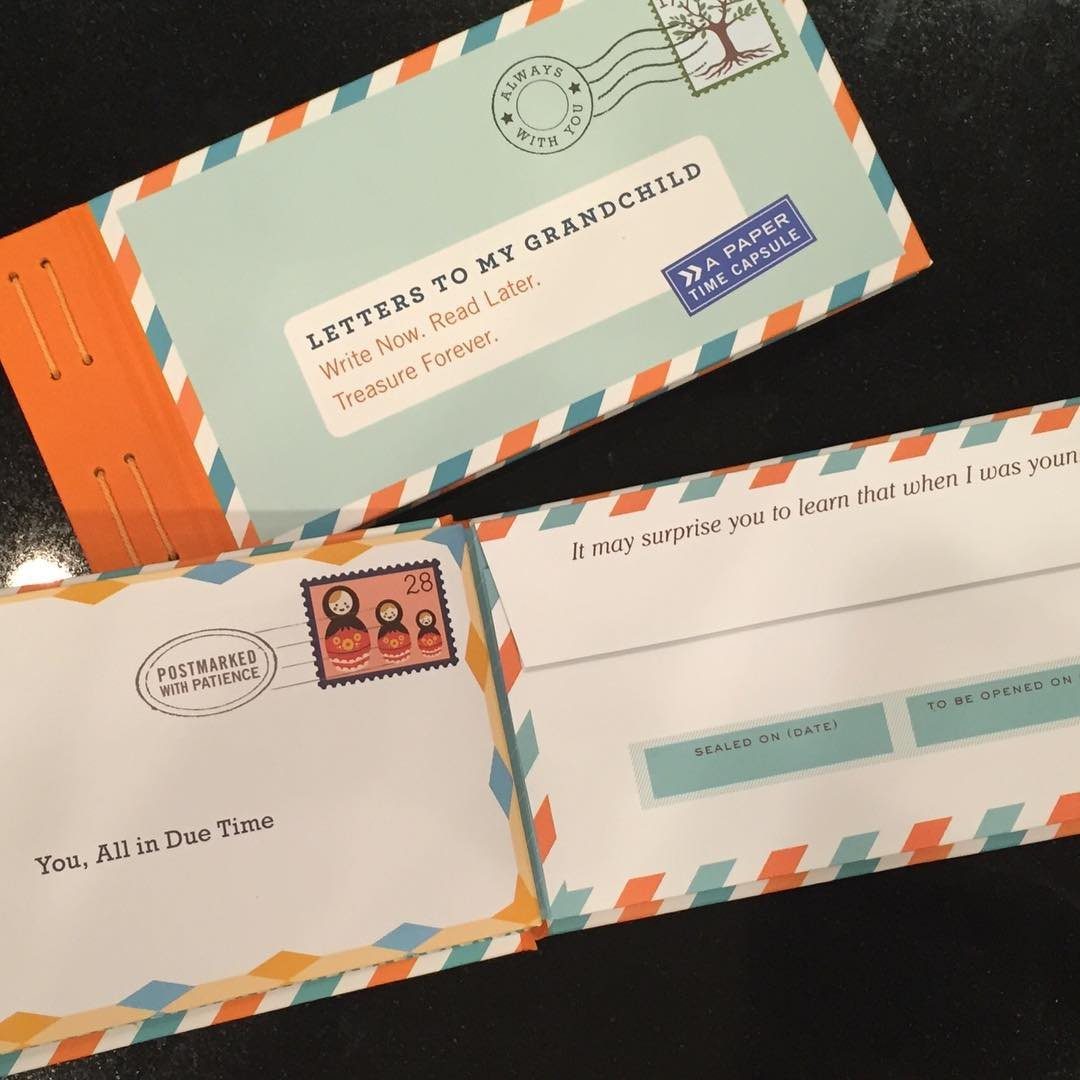 Letters to My Grandchild book and matching envelopes on a dark surface.