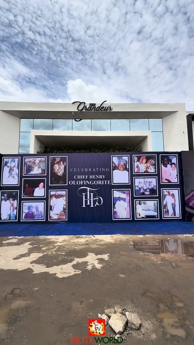 A blue celebratory backdrop with photos and text for a 70th birthday celebration.