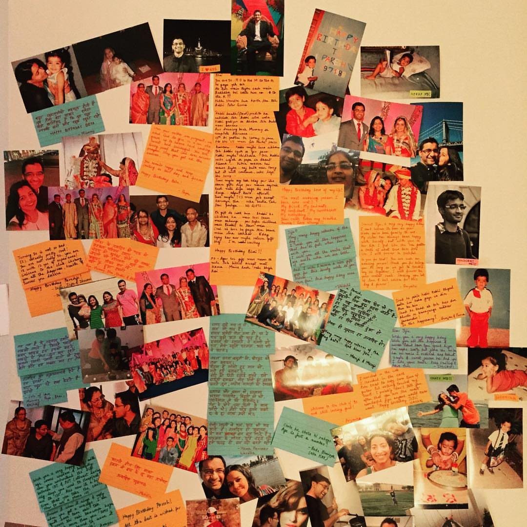 A wall display featuring scattered personal photos mixed with handwritten notes on blue and orange paper.