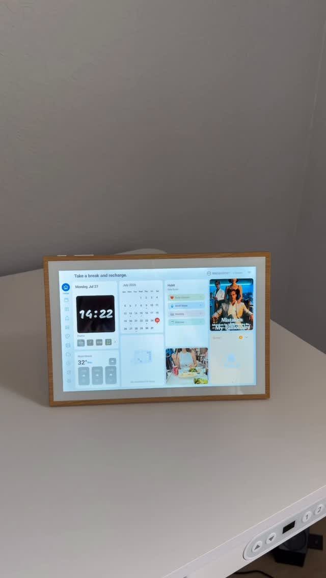 Digital smart display with a wooden frame showing a dashboard of time, weather, and photos.