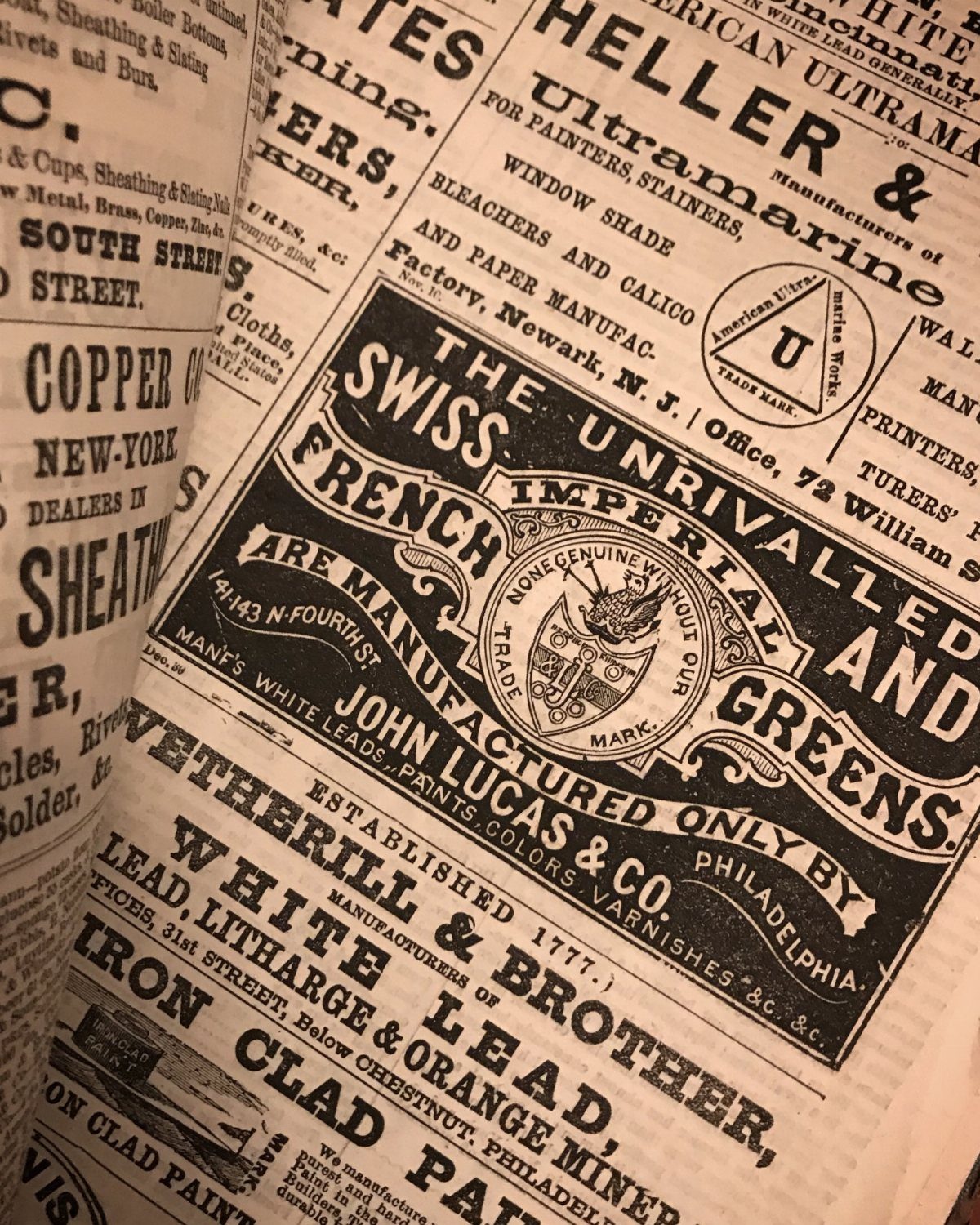 Vintage newspaper pages with aged paper and black ink advertisements for historical products.