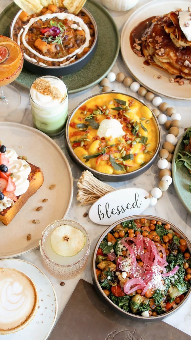 Various seasonal brunch dishes including pumpkin gnocchi and berry French toast arranged on a table.