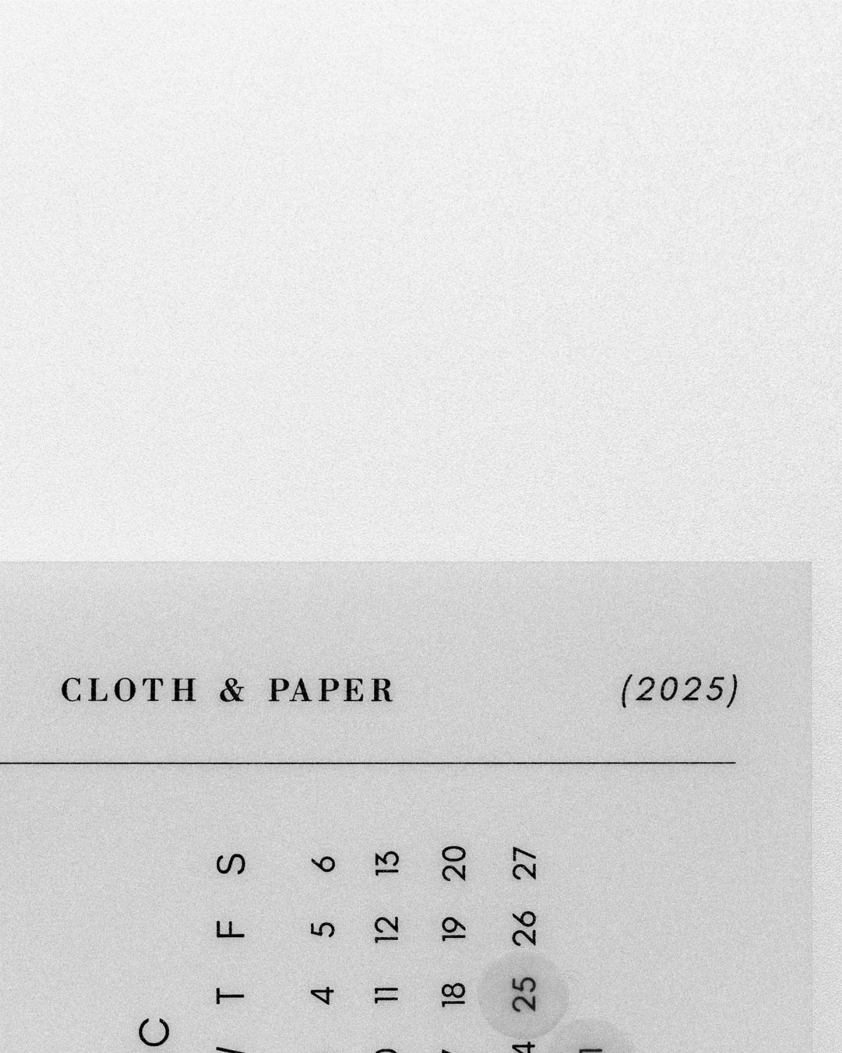 A minimalist gray calendar page showing the year 2025 and various dates.