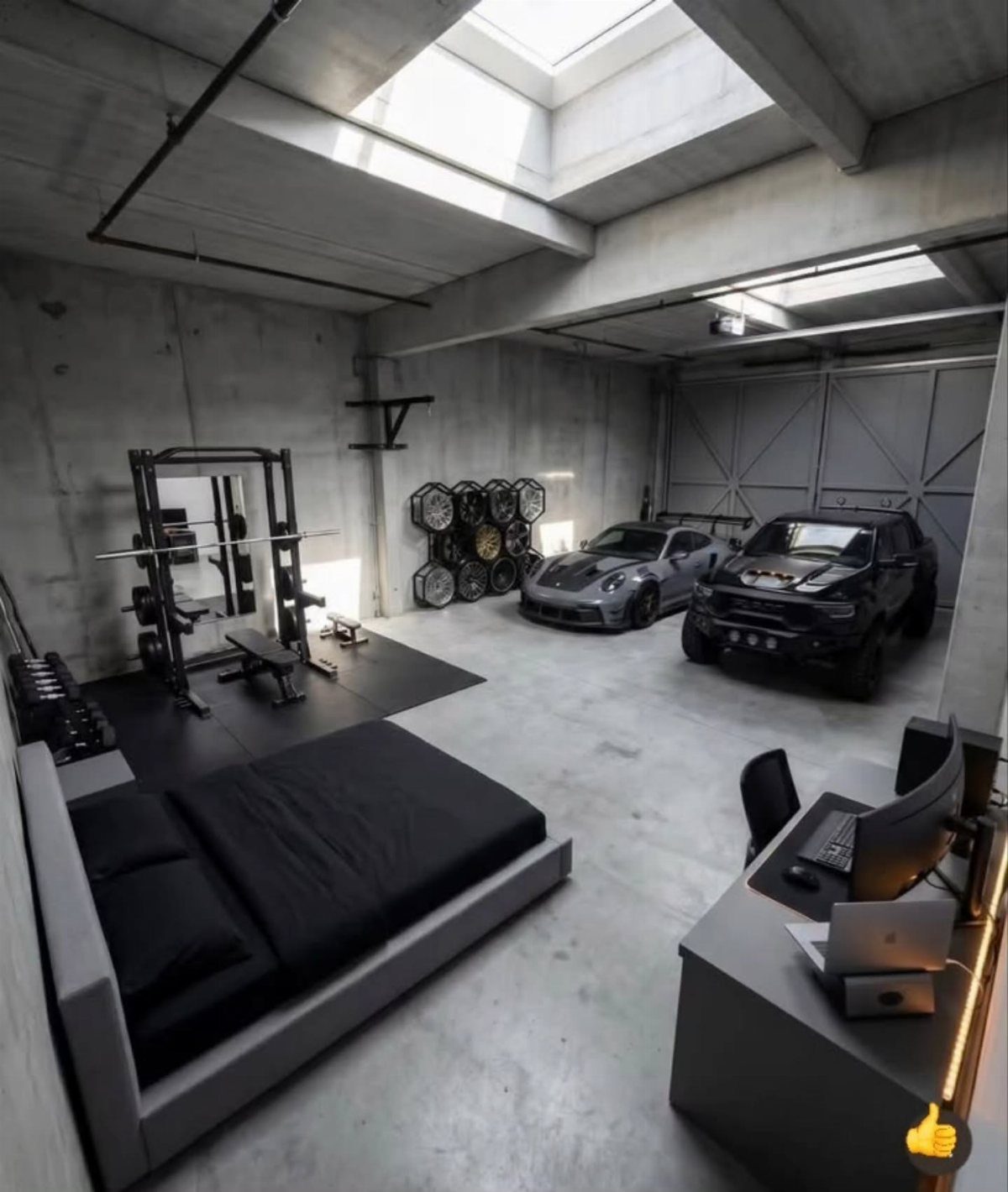 A modern industrial man cave featuring a gym, a bed, a workspace, and luxury cars.