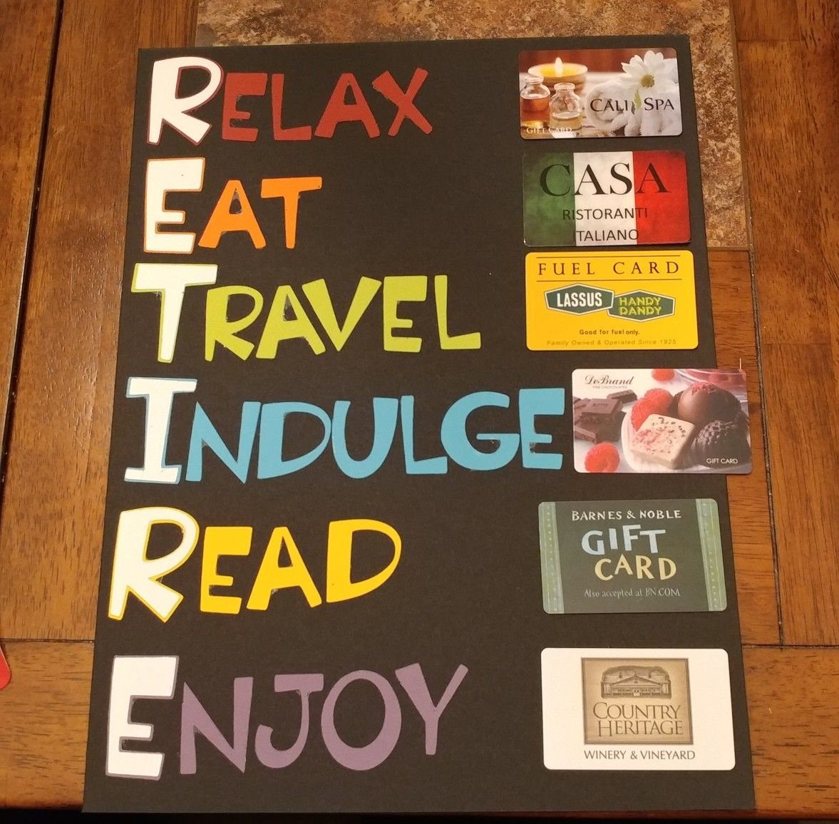 A dark board with colorful letters and various gift cards for dining, travel, and relaxation.